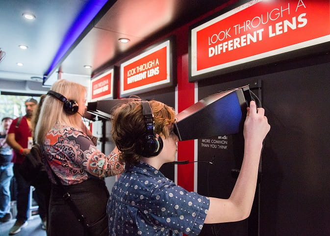 Visitors enjoy virtual reality during the mobile diversity bus tour to learn more about unconscious biases.  